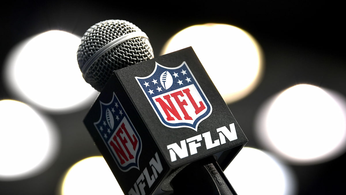 NFL microphone against a backdrop of lights.