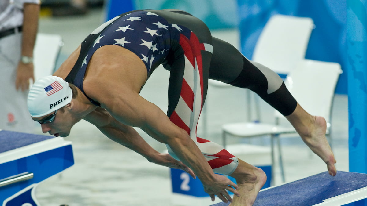 Michael Phelps dives into the pool in the 2008 Olympic Games.