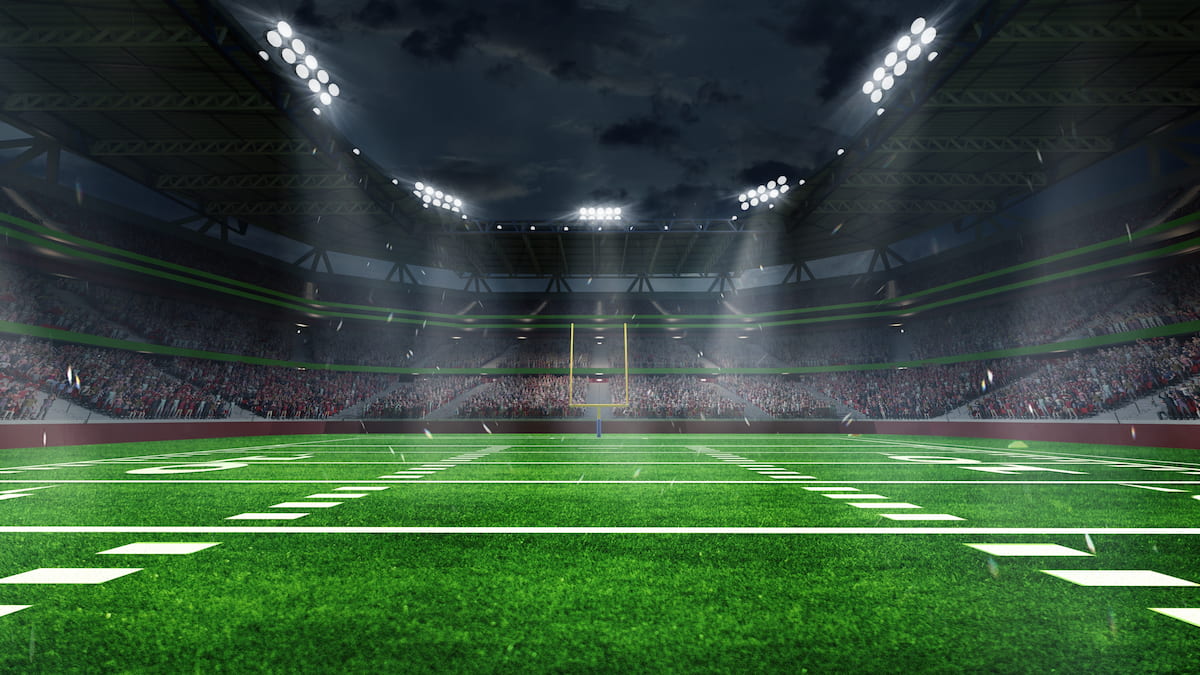 American football stadium under floodlights.