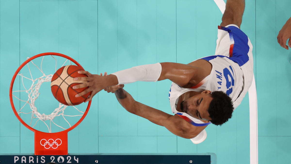 Victor Wembanyama scoring a basket for France at the Paris Olympics.