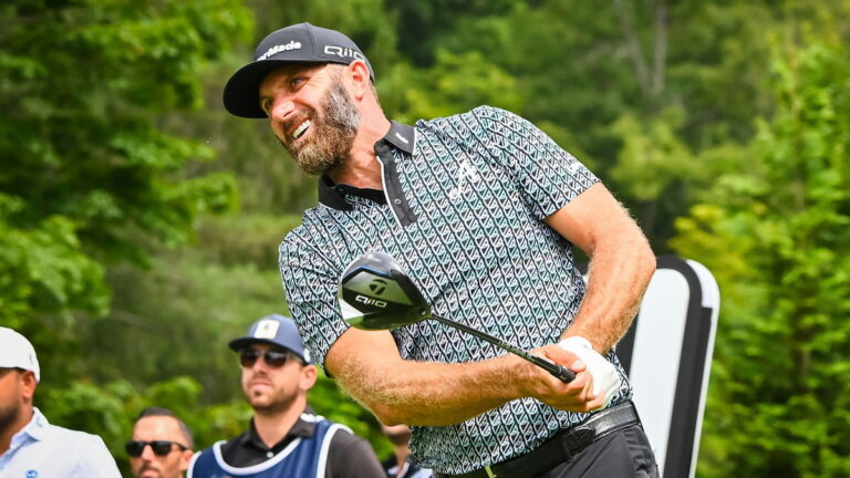 Dustin Johnson follows the ball after hitting his drive.
