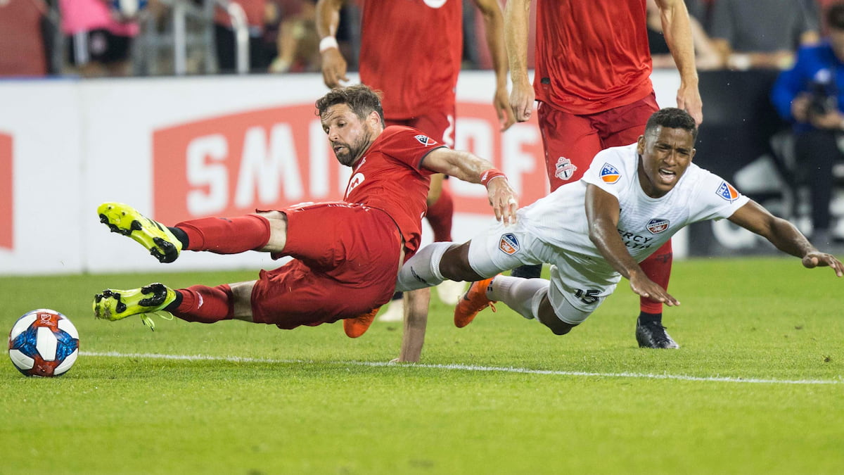 Players from Cincinnati and Toronto clash in an MLS game.