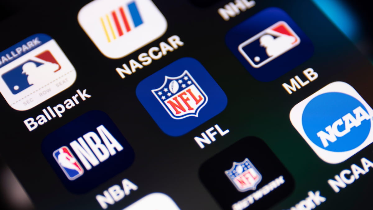 Smartphone showing apps representing major sports leagues.