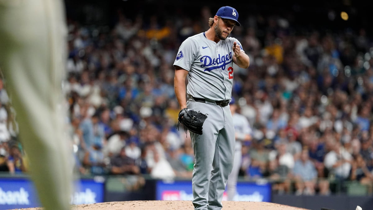 Clayton Kershaw gestures to the umpire after a pickoff attempt in MLB.