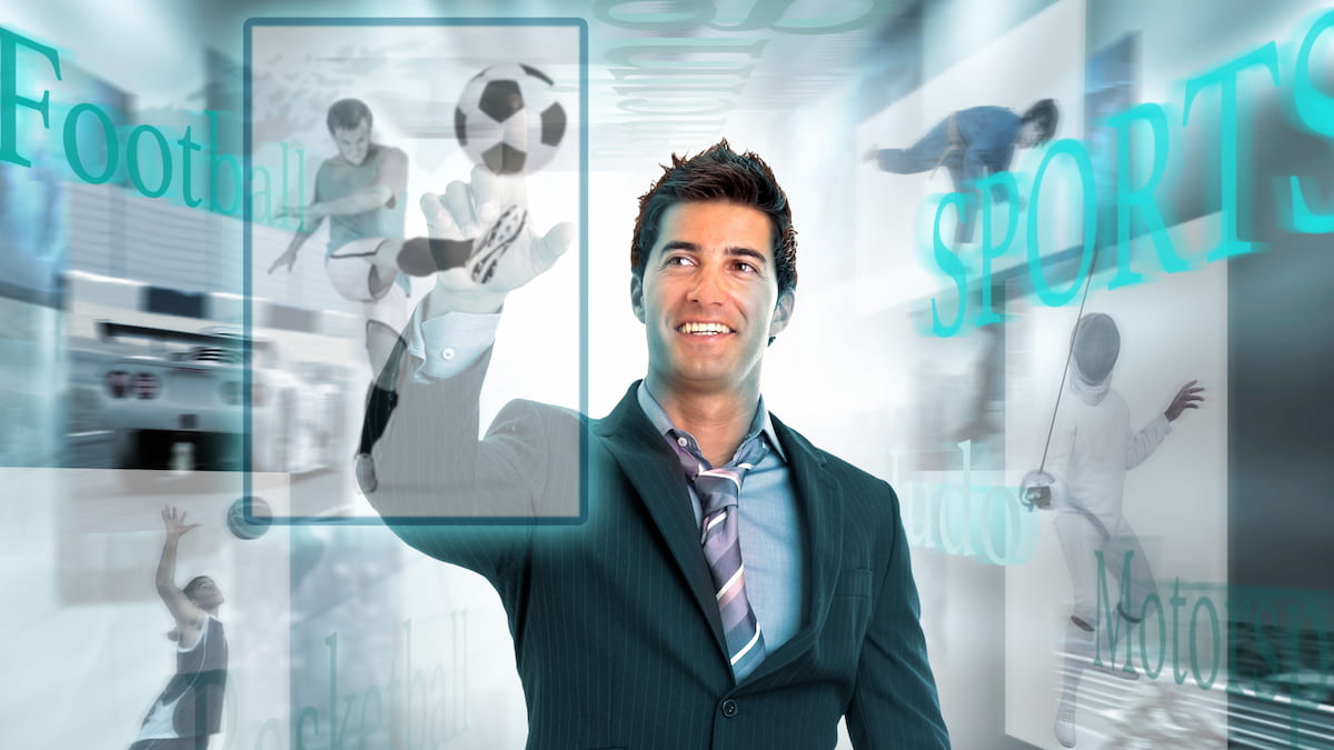Businessman surrounded by high tech screens on sports.