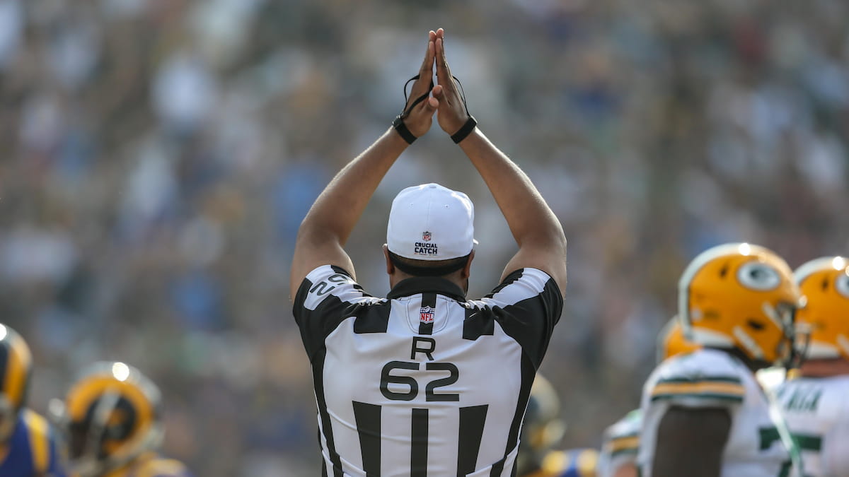 Referee signals a safety in an NFL game.