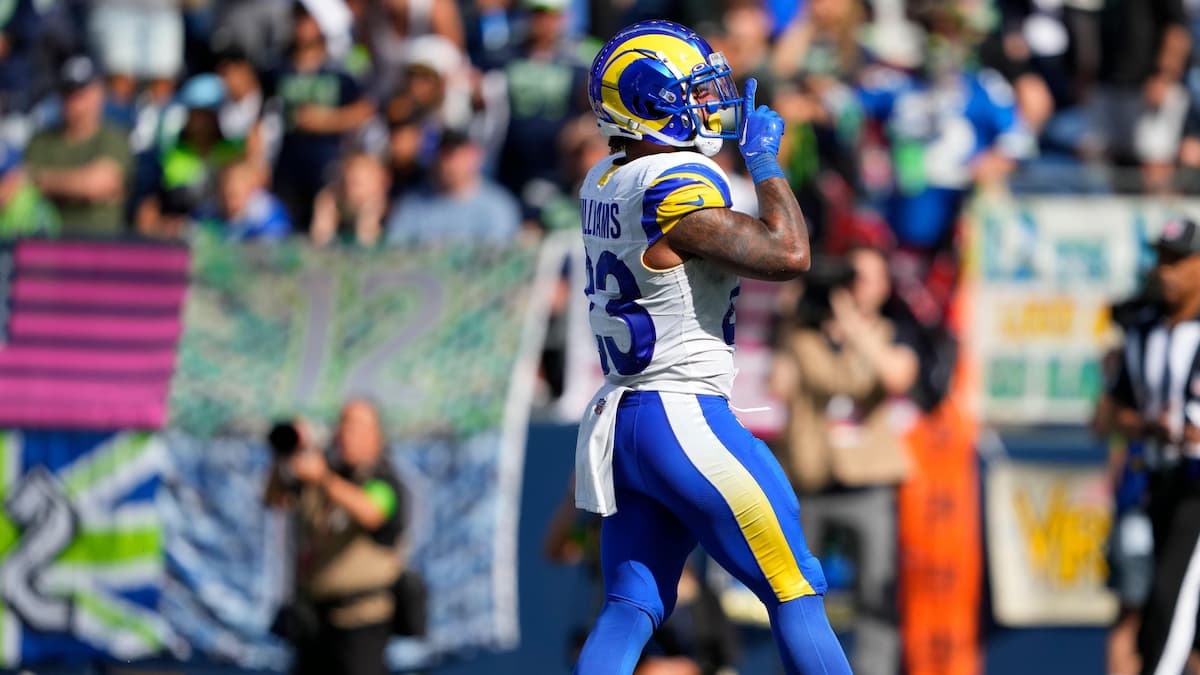 Rams running back Kyren Williams scores a touchdown for LA and gestures to the crowd.