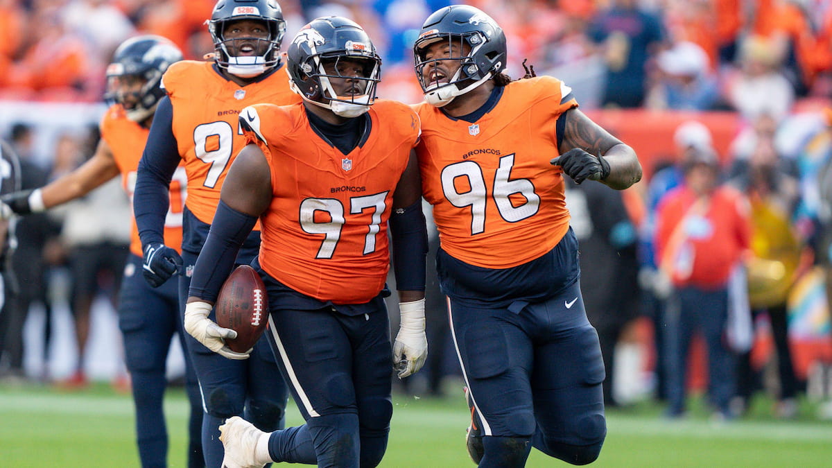 Denver Broncos players celebrate a turnover.
