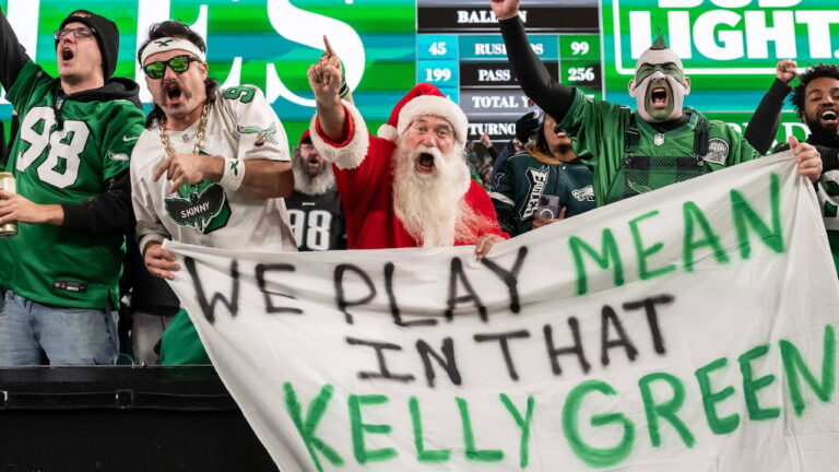 Philadelphia Eagles fans hold up a banner saying 'we play mean in that kelly green'.