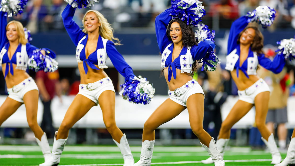 Dallas Cowboys cheerleaders on the field during an NFL game.