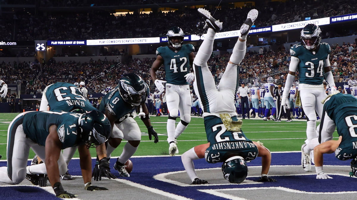 Eagles players celebrate a touchdown by standing on their heads.