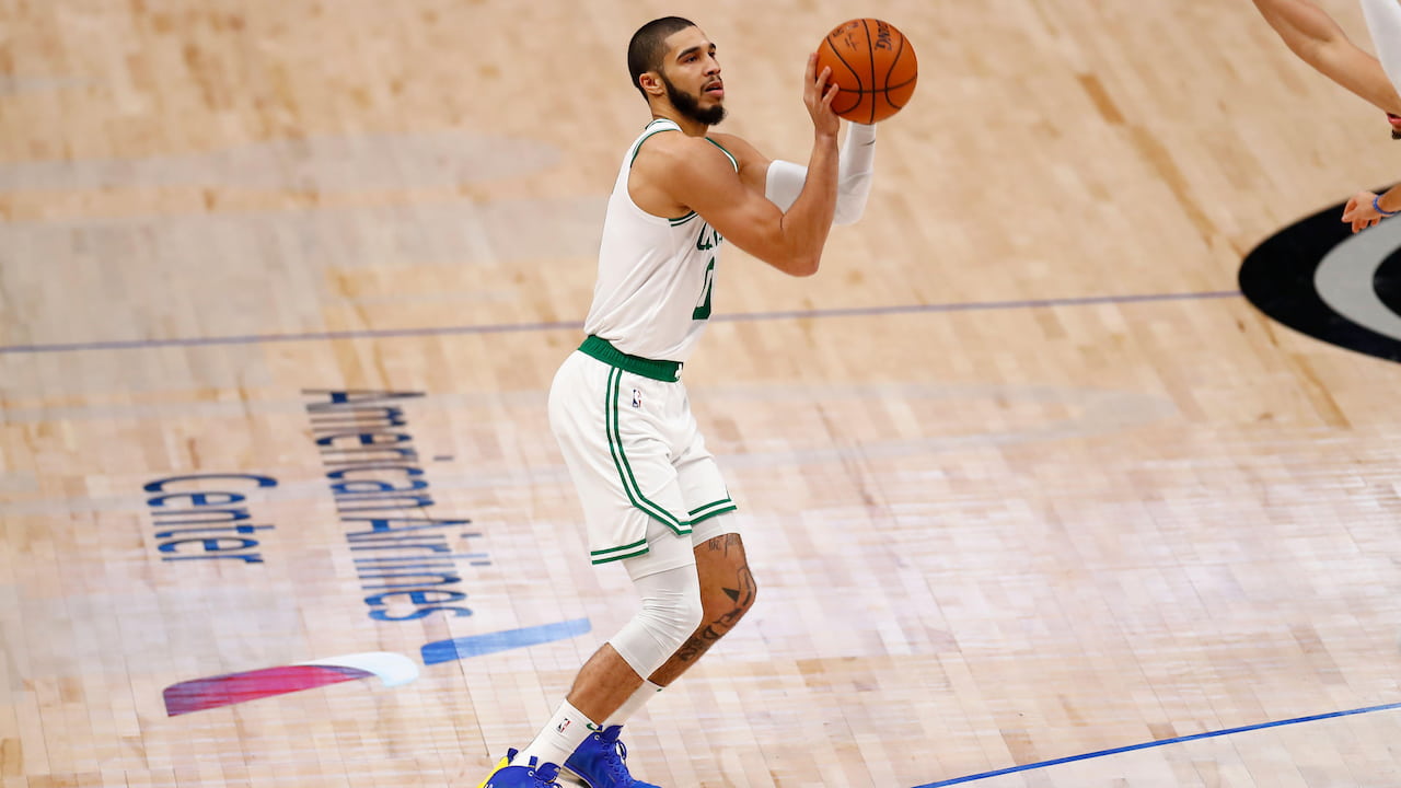 Jayson Tatum taking a three point shot in the NBA