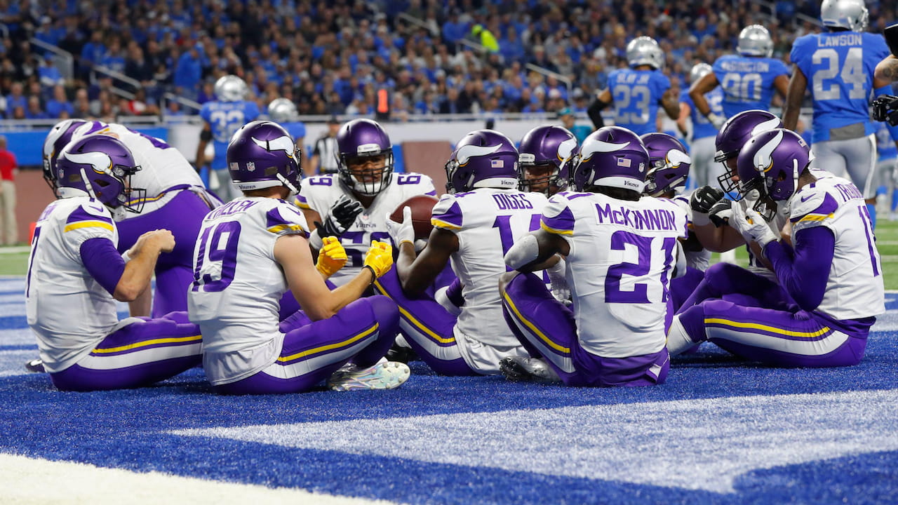 Minnesota Vikings players celebrate a touchdown by pretending to eat Thanksgiving dinner.