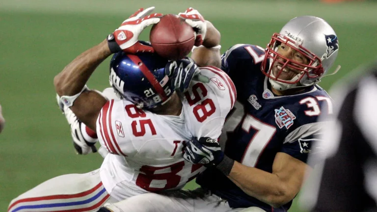 David Tyree famously catches a pass from Eli Manning with help from his helmet on the Giants' game-winning drive in the Super Bowl.