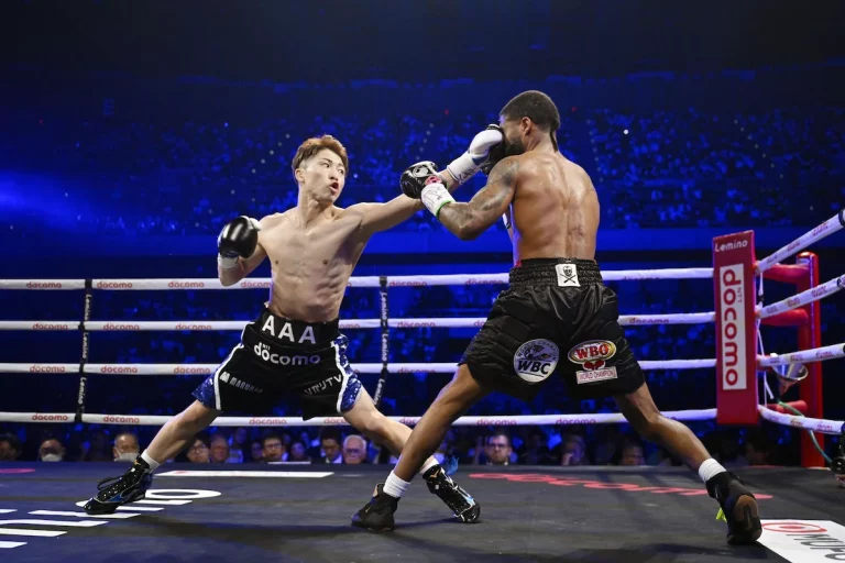 Naoya Inoue throws a punch at Stephen Fulton in their WBO and WBC super bantamweight title fight in Tokyo.
