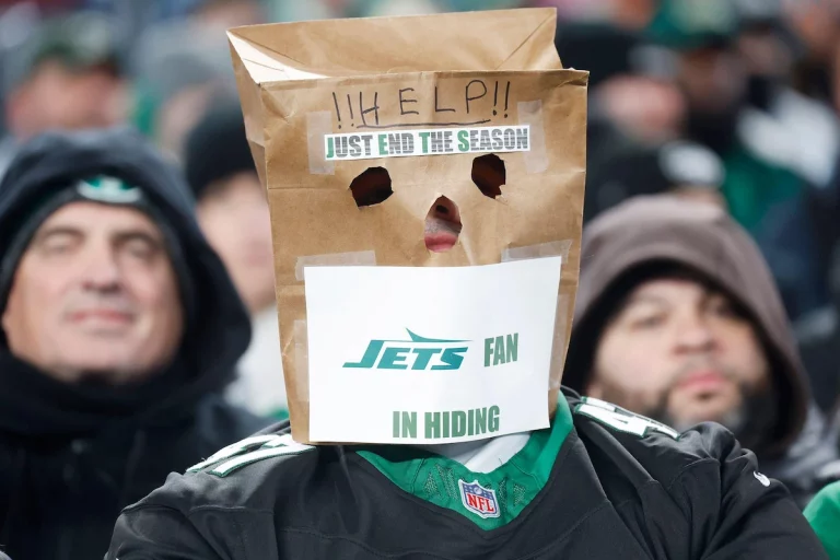 An embarrassed New York Jets fan wears a paper bag over his head during a game at MetLife Stadium.