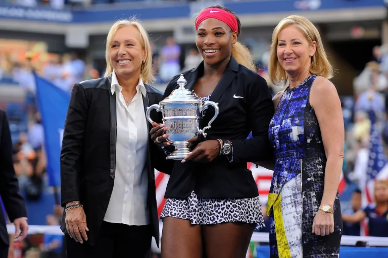 Serena Williams celebrates winning the US Open with other tennis greats Chris Evert and Martina Navratilova.