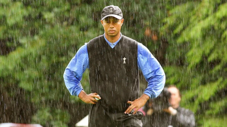 Tiger Woods competing in a PGA tournament in the rain.