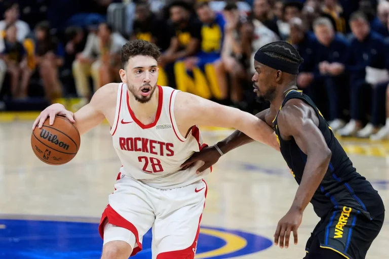 Alperen Sengun dribbles the ball past Jimmy Butler in Game 6 of Rockets vs Warriors in the NBA Playoffs.