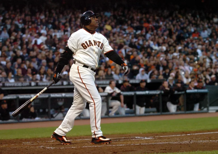 Barry Bonds watches on as he hits a home run for the San Francisco Giants.