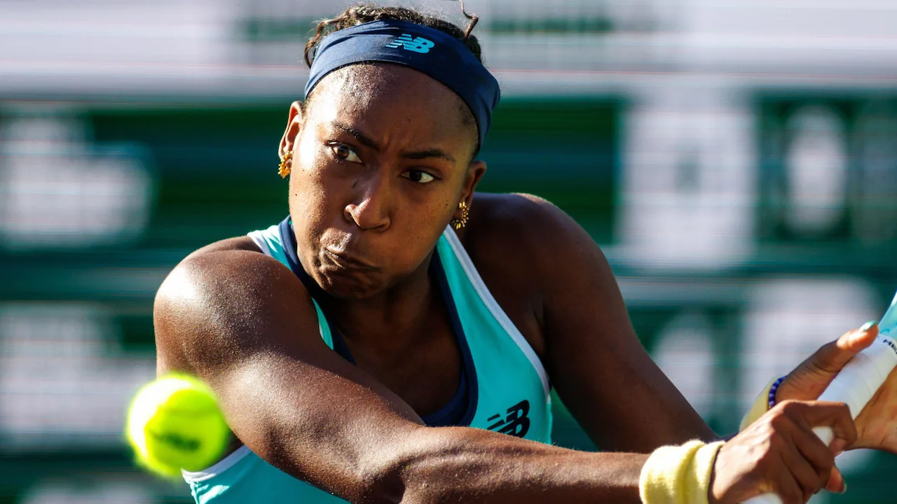 Coco Gauff playing tennis in an ATP tournament.