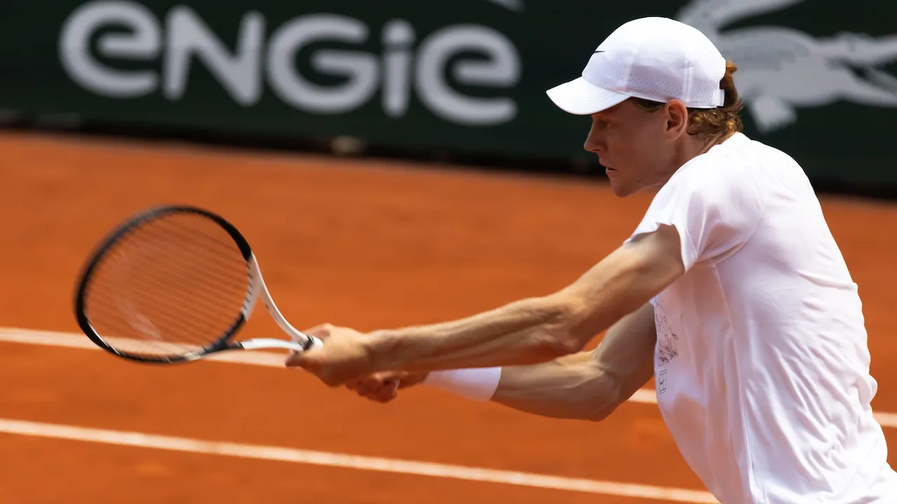 Jannik Sinner playing tennis in an ATP tournament.