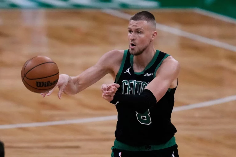 Boston Celtics center Kristaps Porzingis distributes the ball while playing against the Orlando Magic.