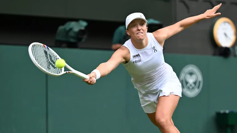 Iga Swiatek playing at 2025 Wimbledon.
